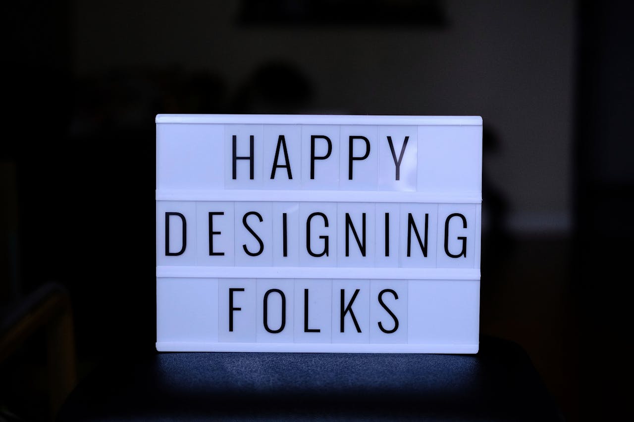 The Art of Drawing Readers In: Your attractive post title goes here Inspirational lightbox sign reading 'Happy Designing Folks' for creatives and designers.